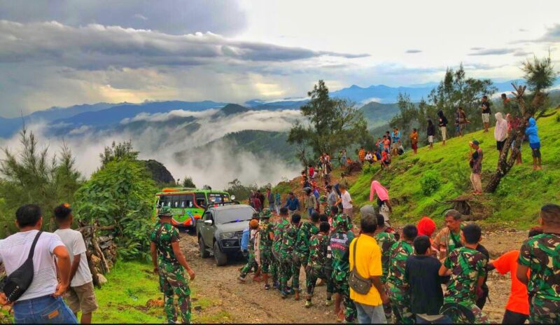 Wadansatgas Yonif 743/PSY bersama anggota dan masyarakat, saat mengevakuasi kendaraan masyarakat yang terjebak lumpur di jalan poros Oepoli (Foto : Dok. Dansatgas Pamtas RI - RDTL Yonif 743/PSY)